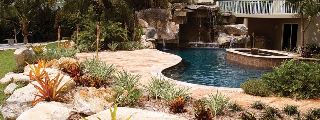 Custom Swimming Pool with Natural Stone Waterfalls and Pool Grotto