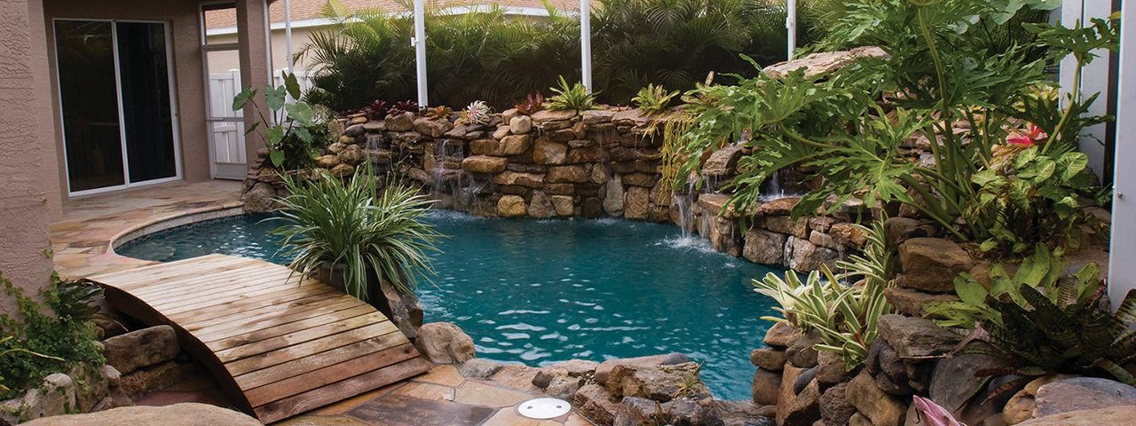 lucas lagoons pool remodel with wooden bridge stream view lagoon-pool