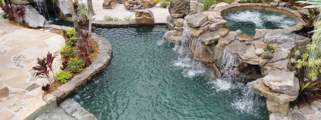 Natural Stone Grotto Waterfall with Elevated Spa Outdoor Designs