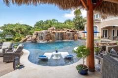 Sun shelf curving around tropical plants and outdoor living space