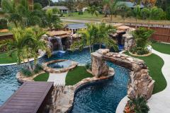 Signature Series Insane Pool with massive grotto and Ipe bridge to the spa island